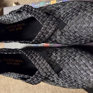 The CLEOPATRA BY Bernie Mev. Metallic Woven Slip-On Flats in Silver and Black